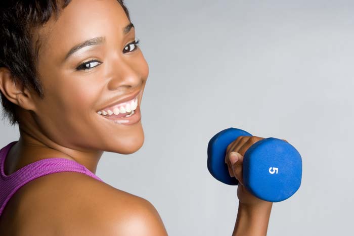 woman working out with weights for self-care